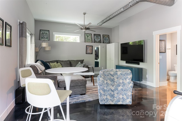 living room with dark hardwood / wood-style flooring and ceiling fan