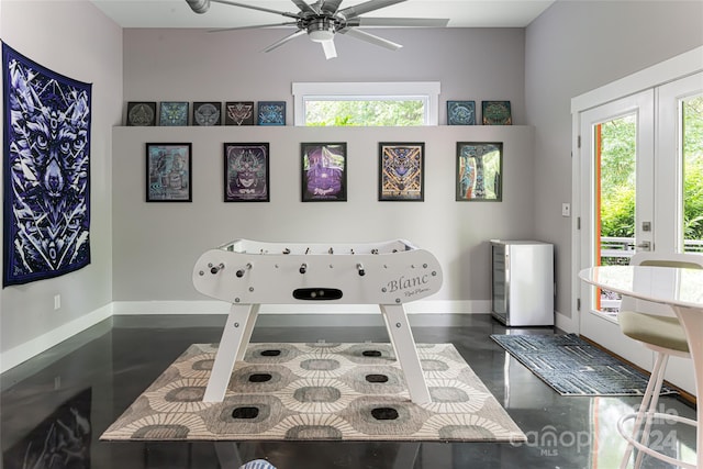 rec room with a high ceiling, ceiling fan, french doors, and a wealth of natural light