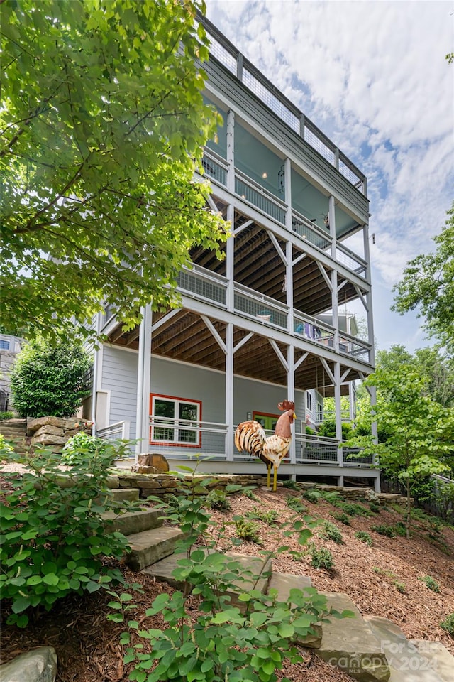 back of property with a balcony