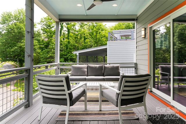 deck with outdoor lounge area and ceiling fan