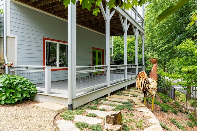 view of property exterior featuring french doors and a deck