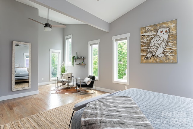 bedroom featuring wood finished floors, high vaulted ceiling, and baseboards