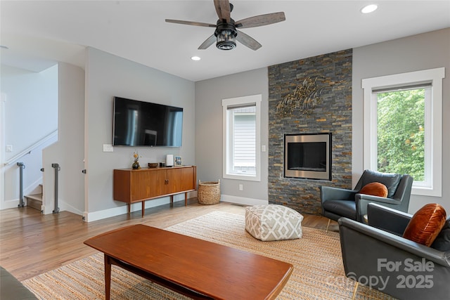 living room with light wood-style floors, recessed lighting, a ceiling fan, and stairway