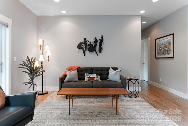 living area featuring baseboards, recessed lighting, and wood finished floors