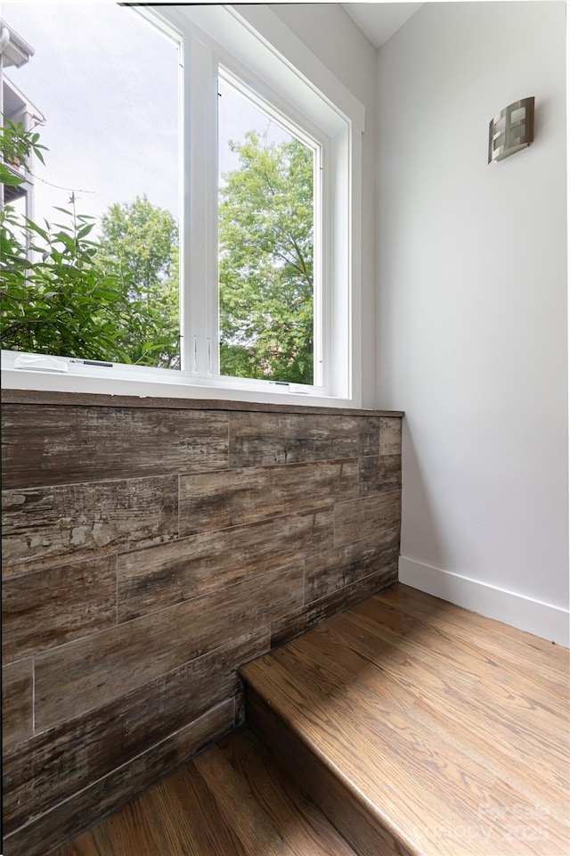 interior space with baseboards and wood finished floors