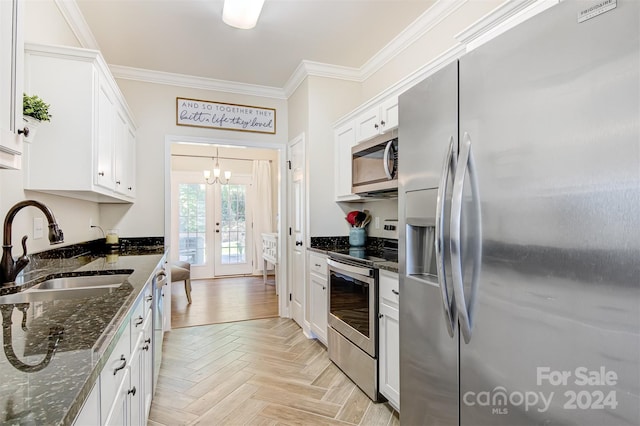 kitchen featuring sink, appliances with stainless steel finishes, light parquet flooring, and dark stone countertops