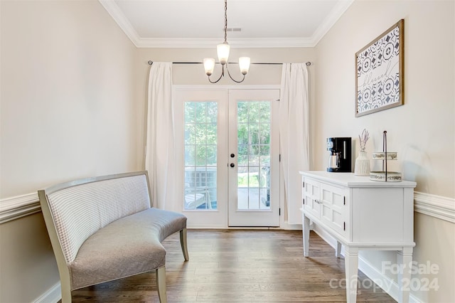 sitting room with hardwood / wood-style floors, a chandelier, ornamental molding, and french doors