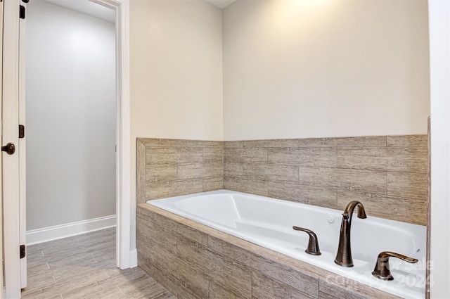 bathroom featuring a relaxing tiled tub