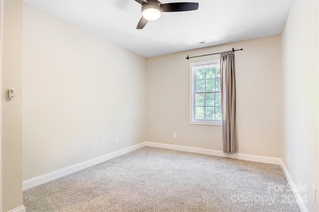 carpeted spare room featuring ceiling fan