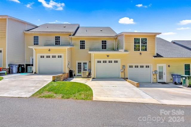 view of property with a garage and french doors