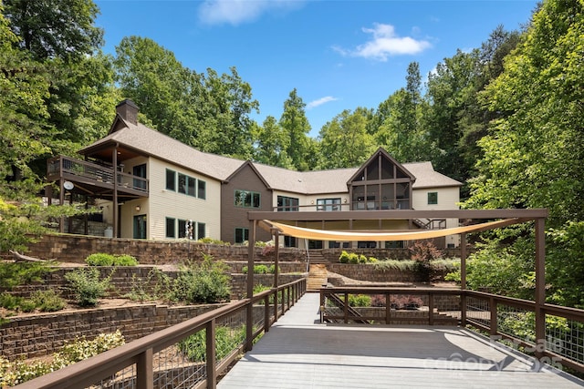 back of house featuring a wooden deck