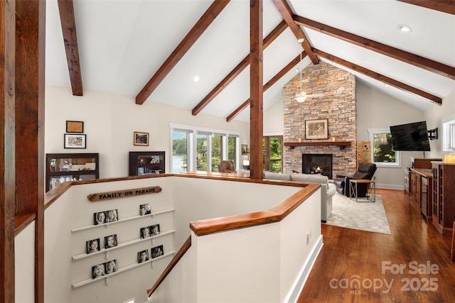 hallway with high vaulted ceiling, dark hardwood / wood-style floors, and beam ceiling