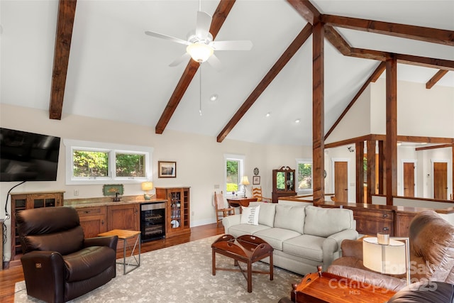 living room featuring wood-type flooring, plenty of natural light, beverage cooler, and high vaulted ceiling