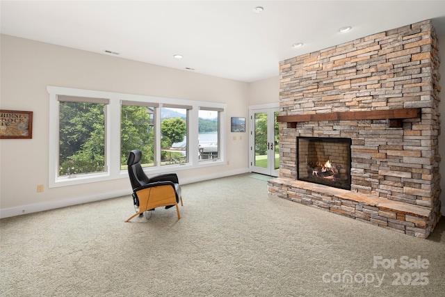 sitting room with a fireplace and carpet