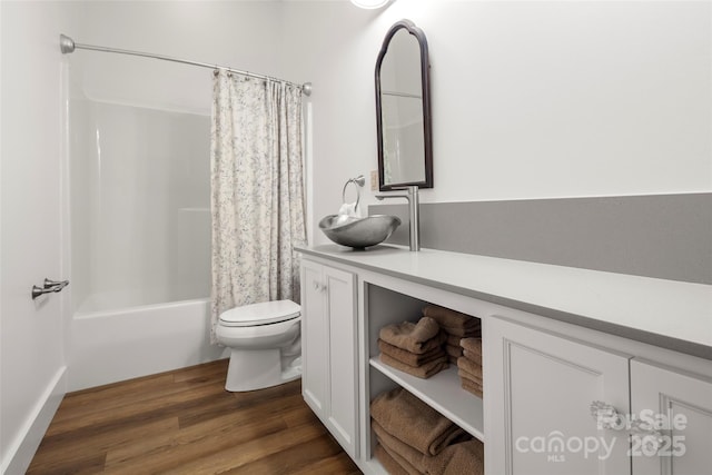 full bathroom with vanity, hardwood / wood-style flooring, shower / bath combination with curtain, and toilet