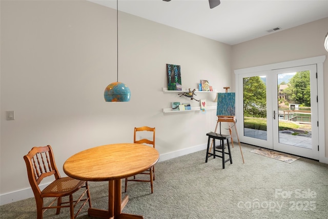 living area with carpet floors, french doors, and ceiling fan