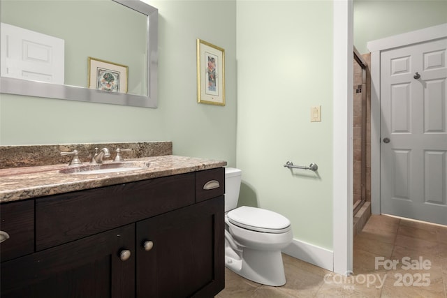 bathroom featuring vanity, toilet, a shower with shower door, and tile patterned flooring