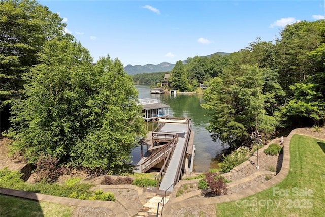 view of dock with a water and mountain view