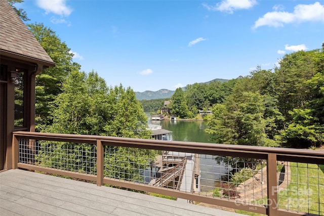 deck with a water and mountain view