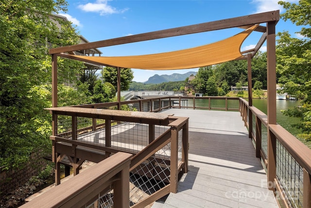 deck with a water and mountain view