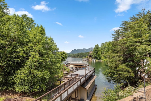 view of dock featuring a water and mountain view