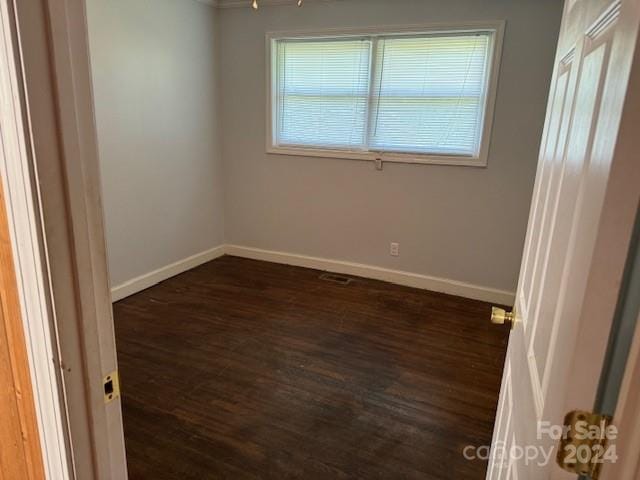 unfurnished room featuring dark hardwood / wood-style floors