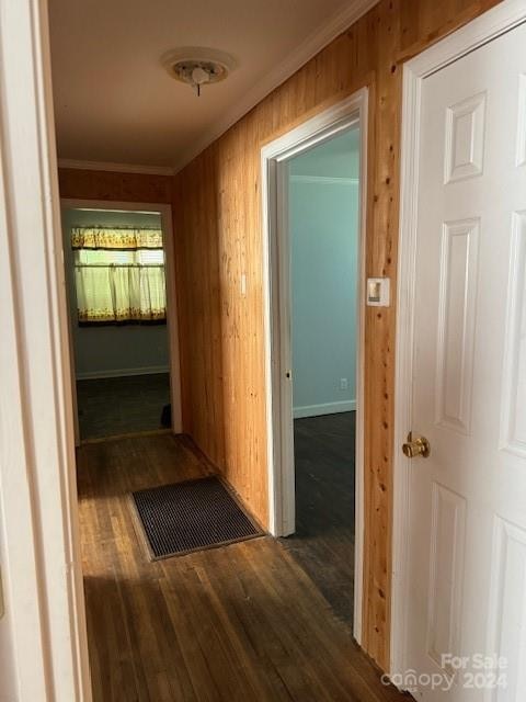 hall featuring wooden walls and dark hardwood / wood-style flooring