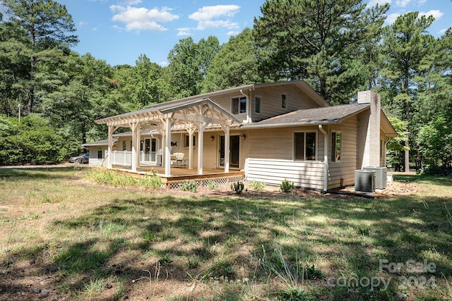 view of front of home with a porch, central AC unit, and a front yard