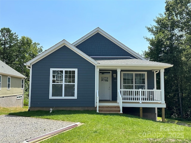 bungalow with a porch and a front lawn