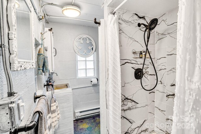 bathroom featuring sink, baseboard heating, and a shower with curtain