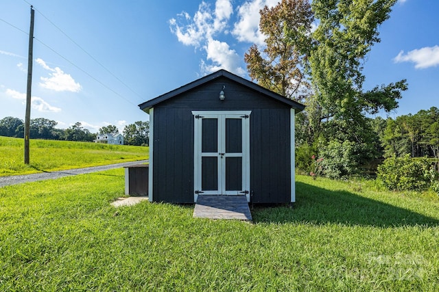 view of outbuilding featuring a yard