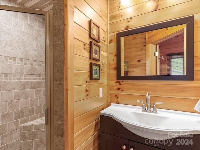 bathroom with oversized vanity, wooden walls, and walk in shower