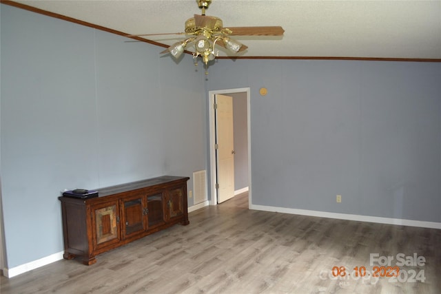 unfurnished room with vaulted ceiling, wood-type flooring, ceiling fan, and crown molding