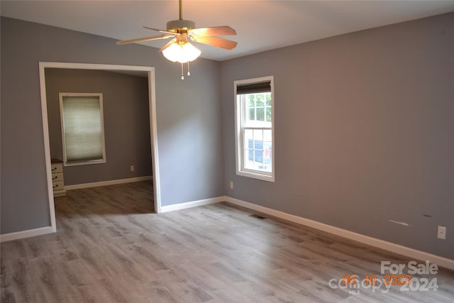 unfurnished room with wood-type flooring and ceiling fan