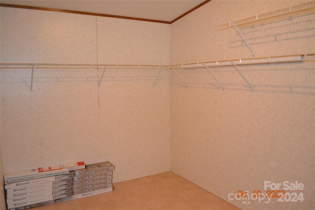 walk in closet featuring tile floors