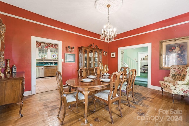 dining space featuring an inviting chandelier and hardwood / wood-style floors