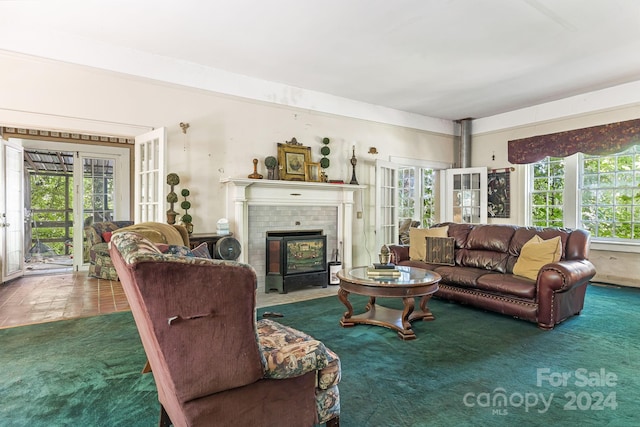 carpeted living room with french doors and a fireplace