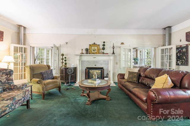 carpeted living room featuring a wealth of natural light, french doors, and a tile fireplace