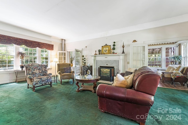 living room featuring french doors, dark carpet, and a tiled fireplace