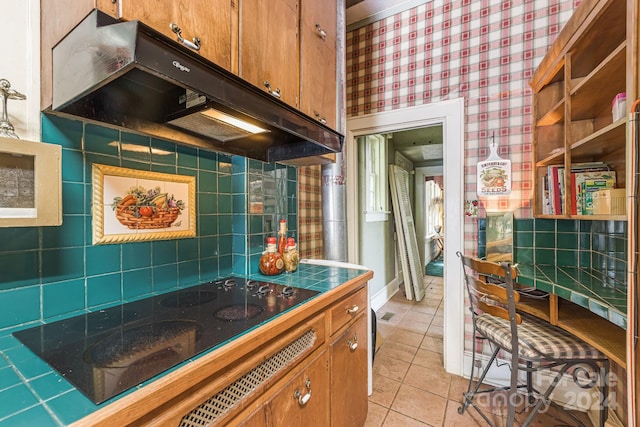 kitchen with light tile patterned floors and black electric stovetop