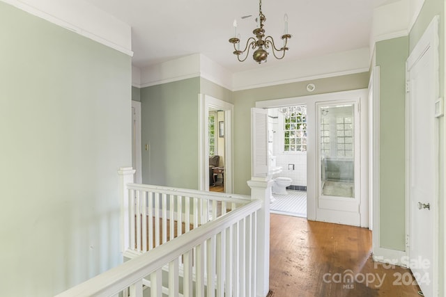 corridor featuring an inviting chandelier and dark hardwood / wood-style floors