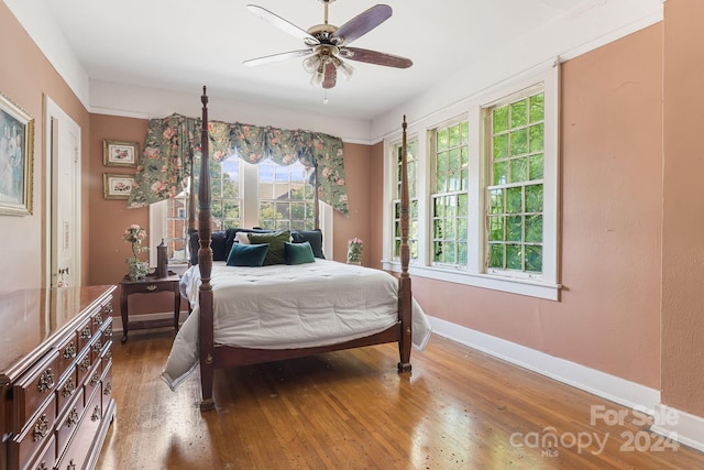 bedroom with ceiling fan and hardwood / wood-style flooring