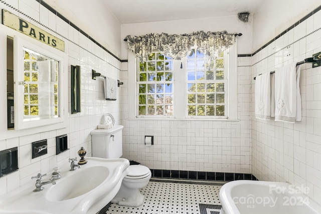 bathroom featuring a tub, tile walls, and toilet