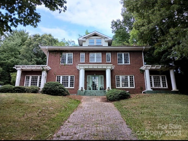 view of front of house with french doors and a front yard