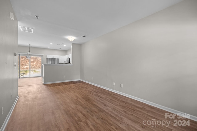 unfurnished living room featuring wood-type flooring