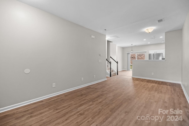 unfurnished room with light hardwood / wood-style flooring