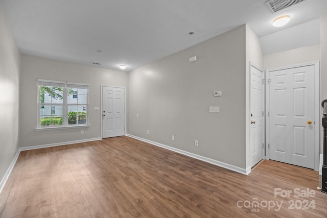 unfurnished room with light wood-type flooring