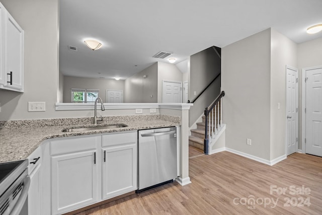 kitchen featuring sink, white cabinets, stainless steel appliances, and light hardwood / wood-style floors