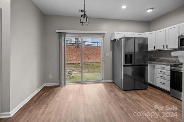 kitchen with light hardwood / wood-style flooring, white cabinets, decorative light fixtures, and appliances with stainless steel finishes