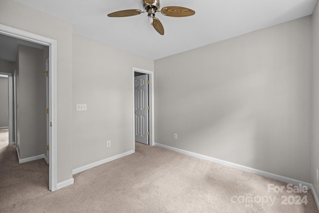 unfurnished bedroom featuring ceiling fan and light carpet